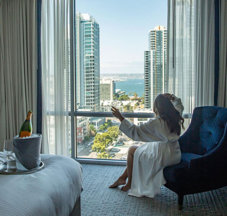 Woman drinking champagne in room